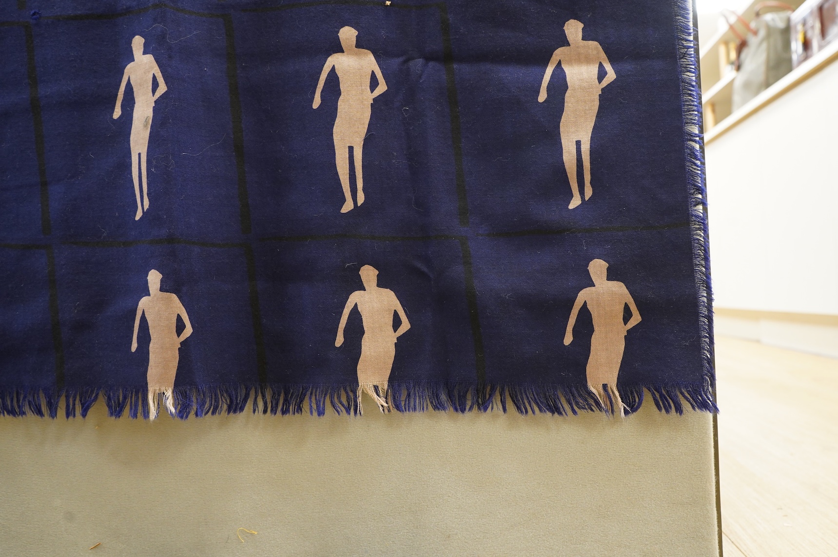 A 1983 blue wool hand printed beige cut out figures fringed - designed by Fraser Taylor of ‘The Cloth’ (RCA 1983)., 97cm x 294cm long. Condition - good